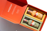 Two Mizzica liqueur bottles in a branded gift box.