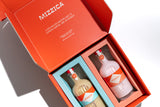 Two Mizzica liqueur bottles in a branded gift box.