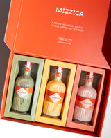 Three Mizzica liqueur bottles in a gift box with the brand name visible.