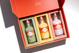 Three Mizzica liqueur bottles in a branded gift box.