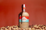 Bottle of Mizzica hazelnut liqueur on a red background