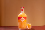 Bottle and glass of Mizzica rockmelon liqueur on a brown background