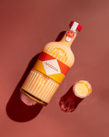 Mizzica bottle and glass on a brown background
