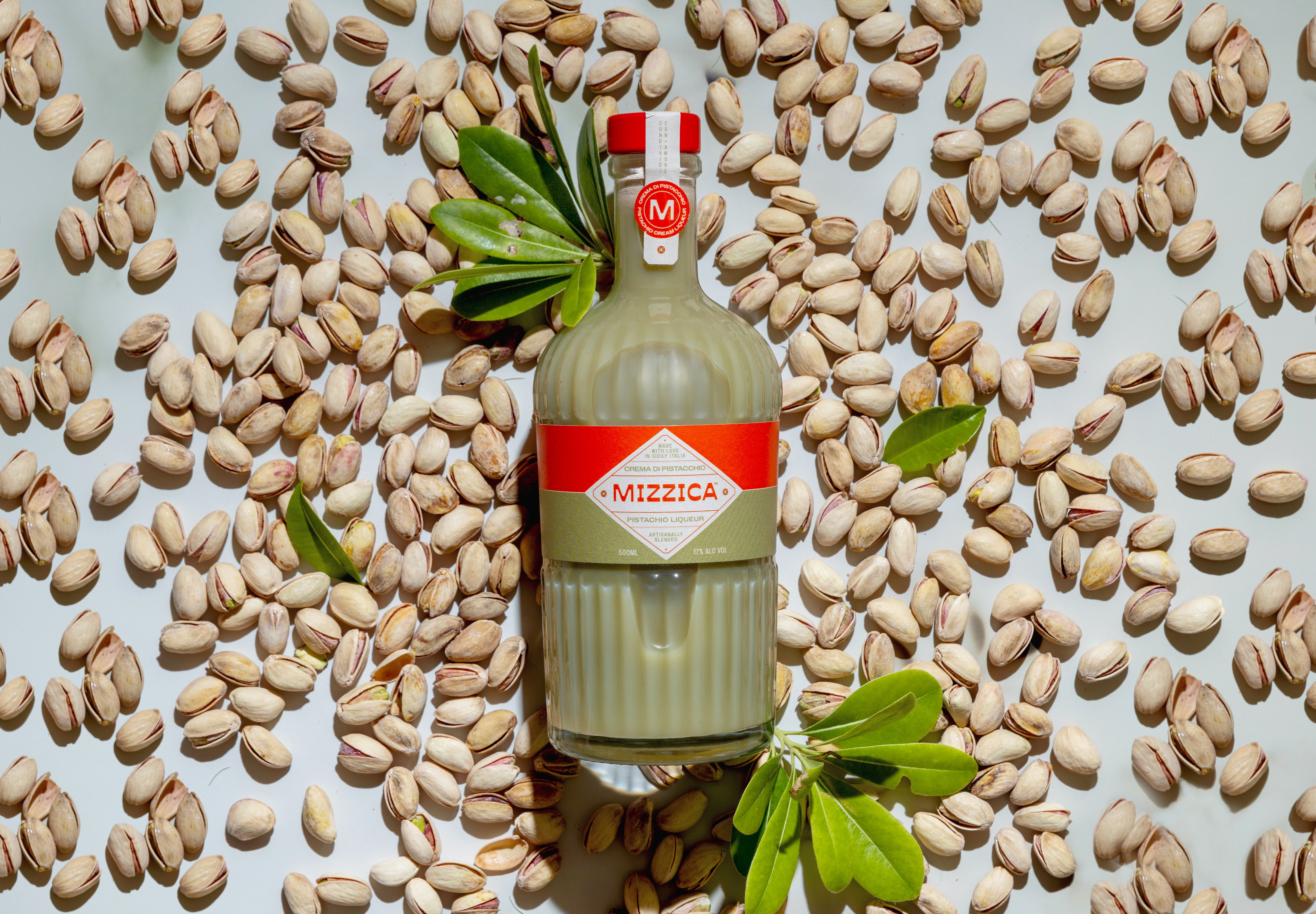 Mizzica pistachio bottle with pistachios on a light background