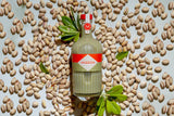 Mizzica pistachio bottle with pistachios on a light background