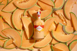 Bottle of Mizzica rockmelon liqueur surrounded by sliced melon